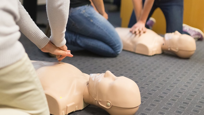 Students practicing CPR on dummies